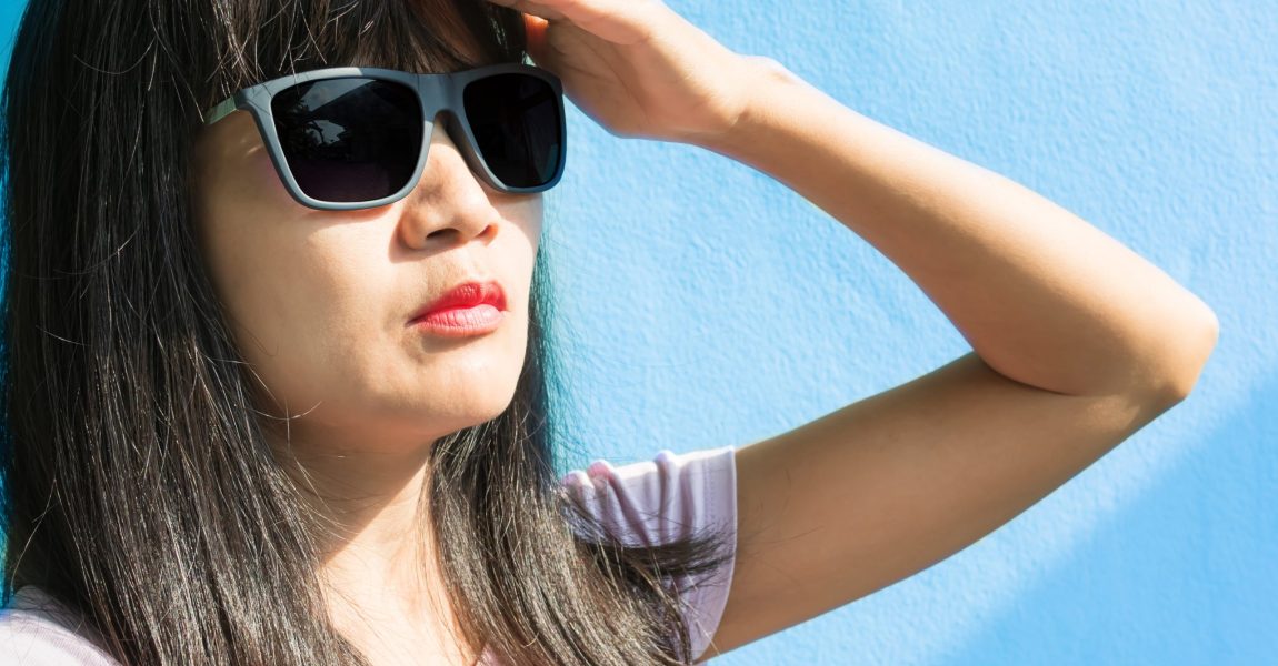 woman wearing sunglasses to protect from uv light, protect her eyesight, eye vision and eye health